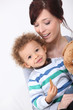 Mother and her son eating a cookie.