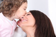 Girl kissing her mother
