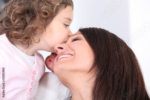 Photo: Girl kissing her mother Girl kissing her mother