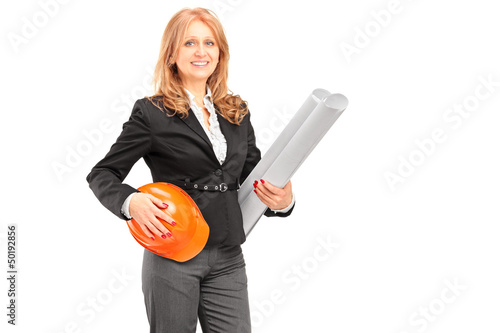 Photo: Female architect holding a blueprint and a helmet Female architect holding a blueprint and a helmet