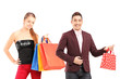 Young man and woman holding shopping bags