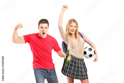 Photo: Young male and female football supporters cheering Young male and female football supporters cheering