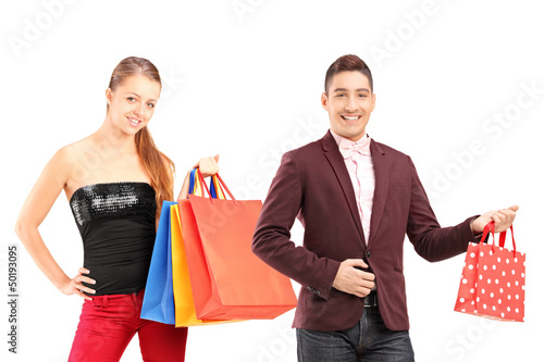 Photo: Young man and woman holding shopping bags Young man and woman holding shopping bags