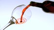 Red wine pouring into glass low angle view