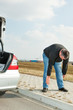 Man doing gymnastics next car