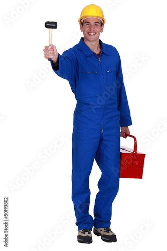 Photo: Man holding mallet and tool kit Man holding mallet and tool kit