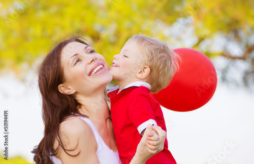 Photo: Little boy kissing mom Little boy kissing mom