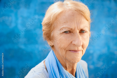 Photo: happy old blond woman smiling and looking at camera happy old blond woman smiling and looking at camera