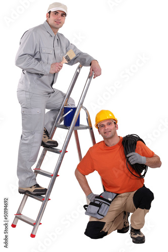 Photo: Painter on a ladder and crouching electrician Painter on a ladder and crouching electrician