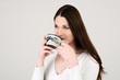 Young attractive white dressed girl drinking tea