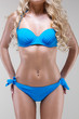 slim model in blue bikini, studio shot