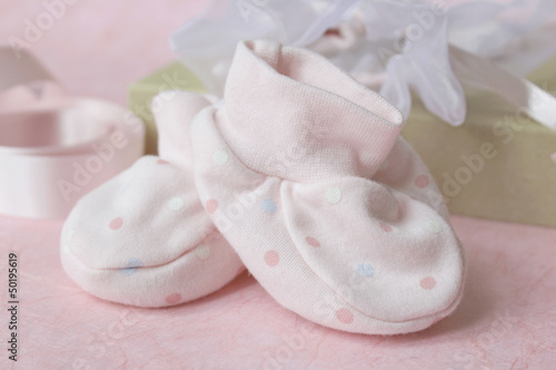 Photo: Pink spotted baby bootees with gift bag and pink ribbon Pink spotted baby bootees with gift bag and pink ribbon