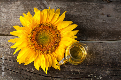 Photo: sunflower oil on wooden table sunflower oil on wooden table