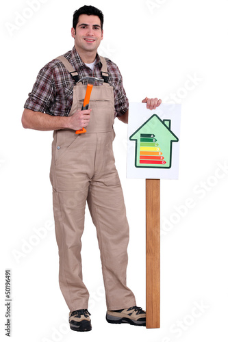 Photo: craftsman putting an energy consumption label craftsman putting an energy consumption label