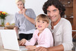 Foto: Parents and little girl with laptop Parents and little girl with laptop