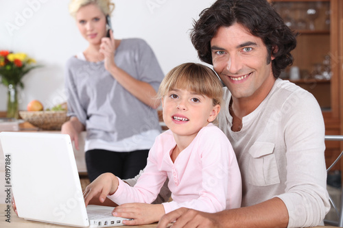 Photo: Parents and little girl with laptop Parents and little girl with laptop