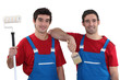 Two painters wearing matching outfits