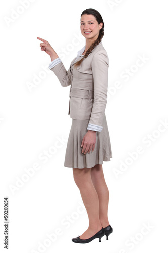 Photo: smiling young woman pointing at someone isolated on white smiling young woman pointing at someone isolated on white