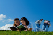 Two girls reading books outside