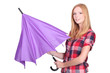 Young woman opening a purple umbrella
