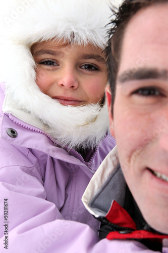 Photo: Portrait of a man with little girl by wintertime Portrait of a man with little girl by wintertime