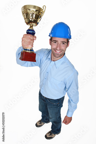 Photo: An architect holding a trophy. An architect holding a trophy.