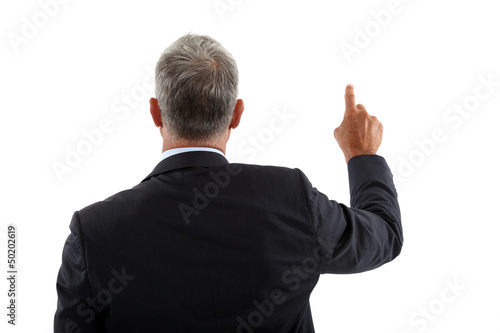 Photo: view of a back of a businessman pushing a button view of a back of a businessman pushing a button