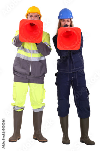 Photo: Two traffic workers shouting through cones Two traffic workers shouting through cones