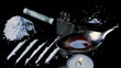 Drugs cooking on a spoon with lines racked up and large pile