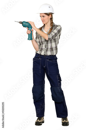 Photo: Tradeswoman using a drill Tradeswoman using a drill