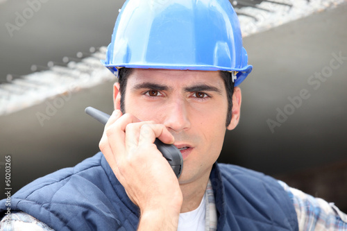 Photo: Builder on walkie talkie Builder on walkie talkie