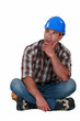A pensive manual worker.