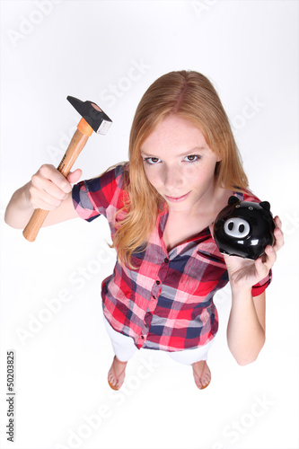 Photo: Teenager with hammer and piggy-bank Teenager with hammer and piggy-bank