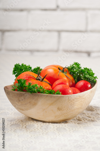 Photo: tomatoes on a wood bowl tomatoes on a wood bowl