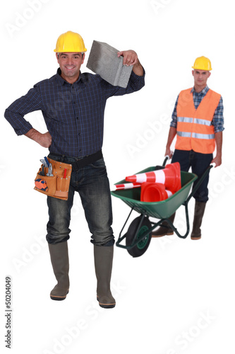 Photo: Man with traffic cones and wheelbarrow Man with traffic cones and wheelbarrow