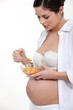 Pregnant woman eating cereal
