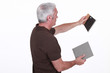 craftsman holding a tile and a tool