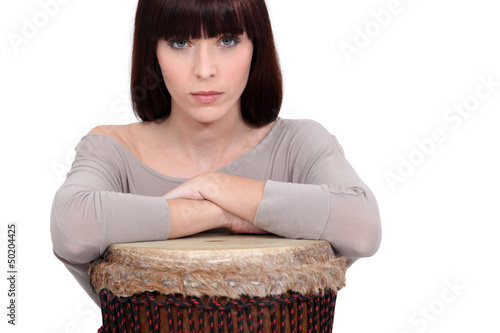 Photo: Woman leaning on a djembe Woman leaning on a djembe