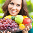 Woman with plate of fruits, outdoors