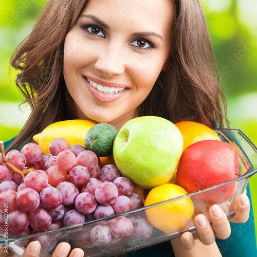Photo: Woman with plate of fruits, outdoors Woman with plate of fruits, outdoors