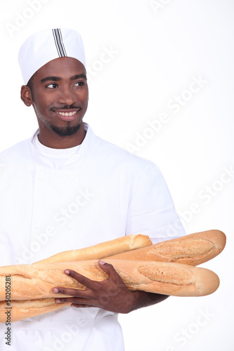 Photo: Baker with an armful of baguettes Baker with an armful of baguettes