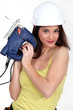 foxy female carpenter holding sander machine