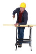 Worker sawing wood