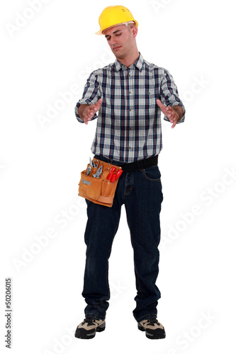 Photo: Tradesman holding an invisible object Tradesman holding an invisible object