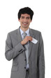 Young businessman removing business-card from pocket