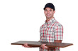 craftsman holding a few floor boards