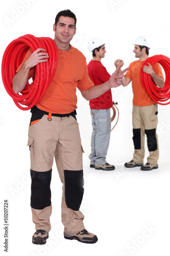 Photo: Three male plumbers Three male plumbers