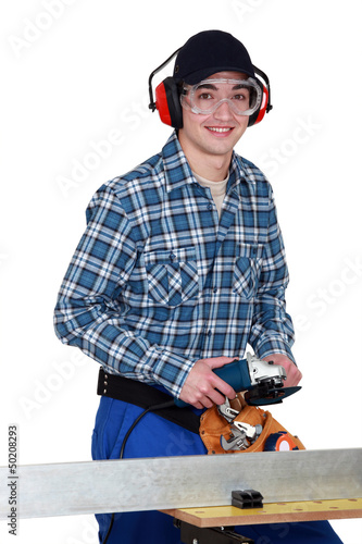 Photo: Man using angle grinder Man using angle grinder