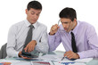 Businessmen scrutinizing financial results