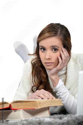 Photo: Serious young woman reading books Serious young woman reading books